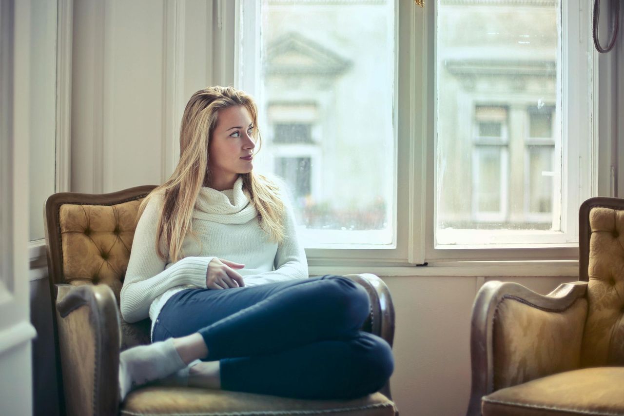 women sat next to windows c